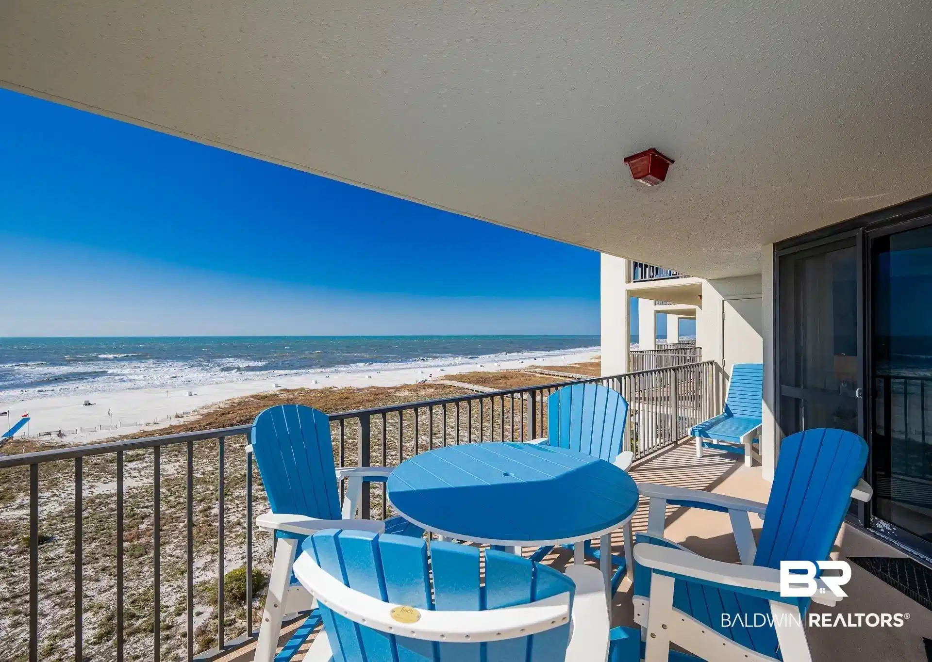 Image 1: Balcony with view of water and beach and outdoor dining area