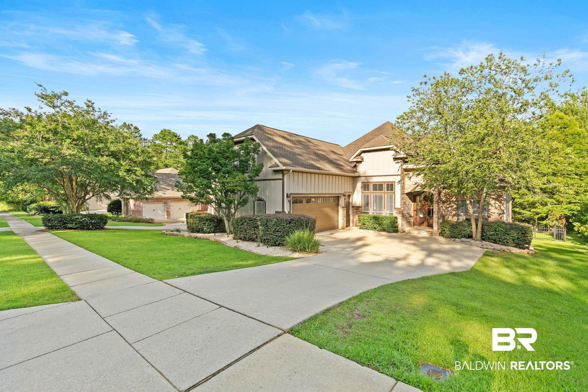 Image 3: Contemporary residence featuring a multi-gabled roofline and a combination of vertical siding and stone facade