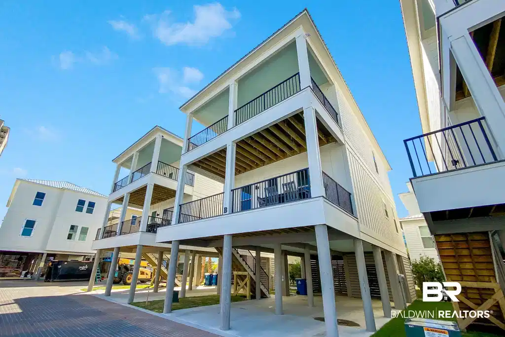 Image 1: Rear view of house featuring a carport and stairs