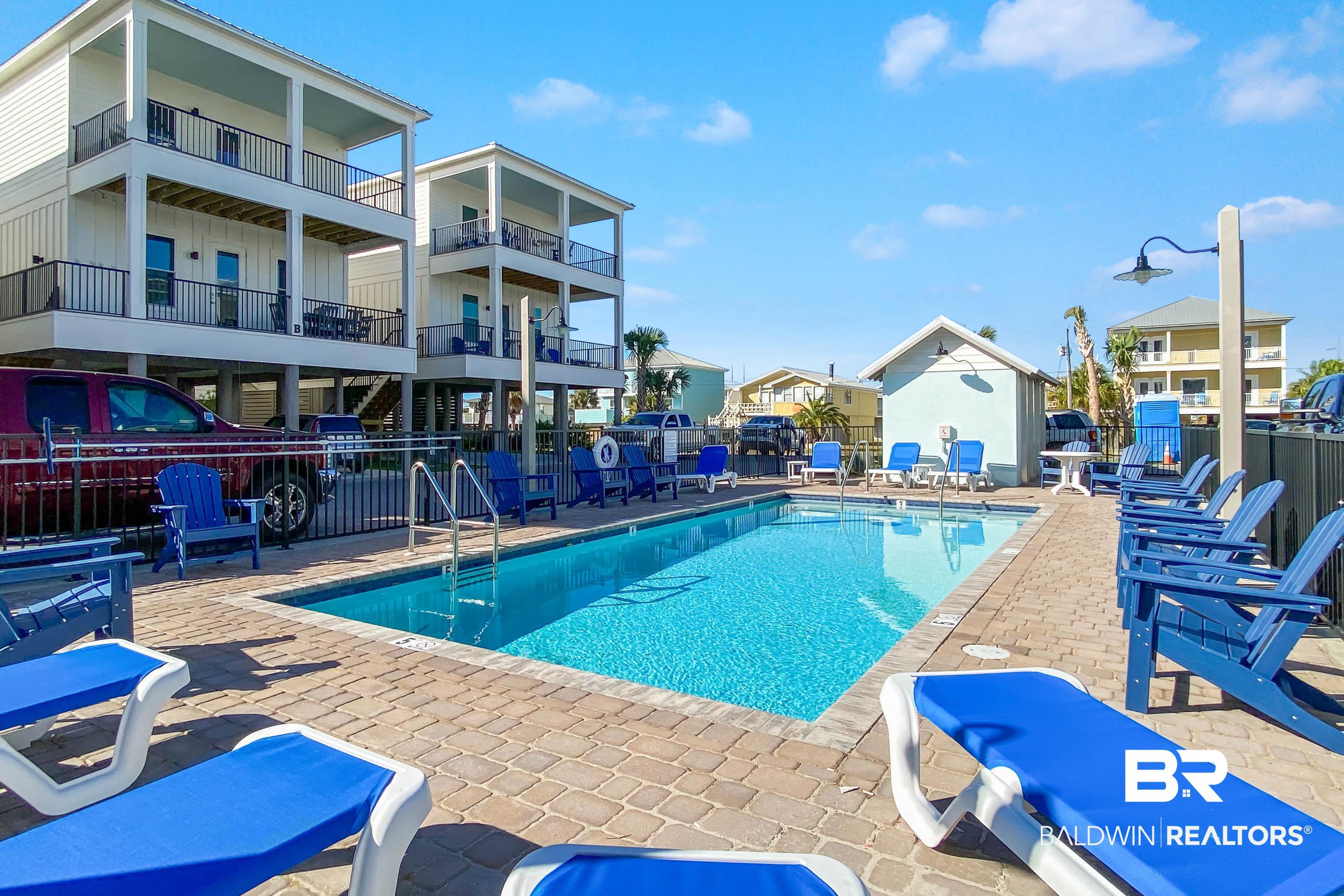 Image 2: Community pool featuring a patio, a residential view, and a grill
