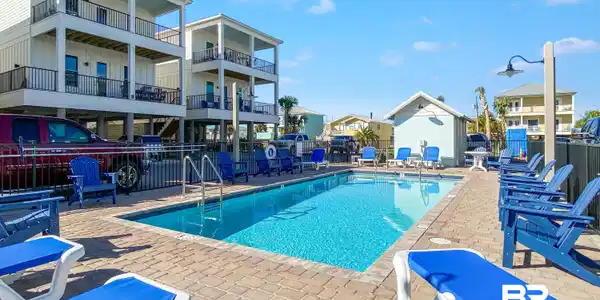 Image 2: Community pool featuring a patio, a residential view, and a grill