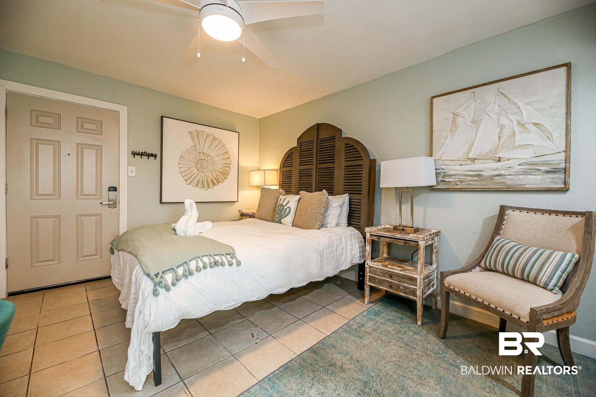 Image 2: Bedroom with light tile patterned flooring and ceiling fan