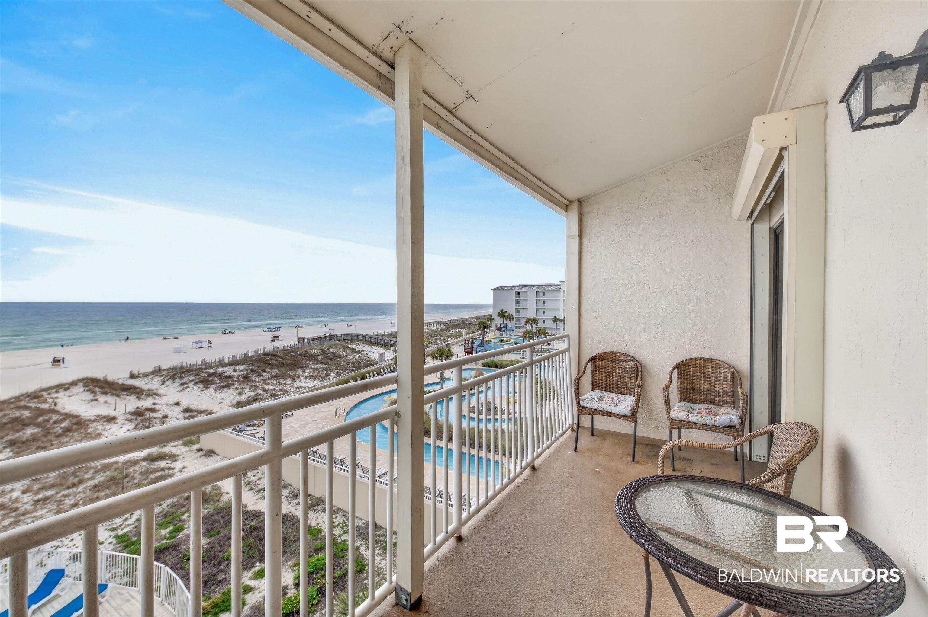 Image 3: Private balcony featuring concrete flooring and a white railing