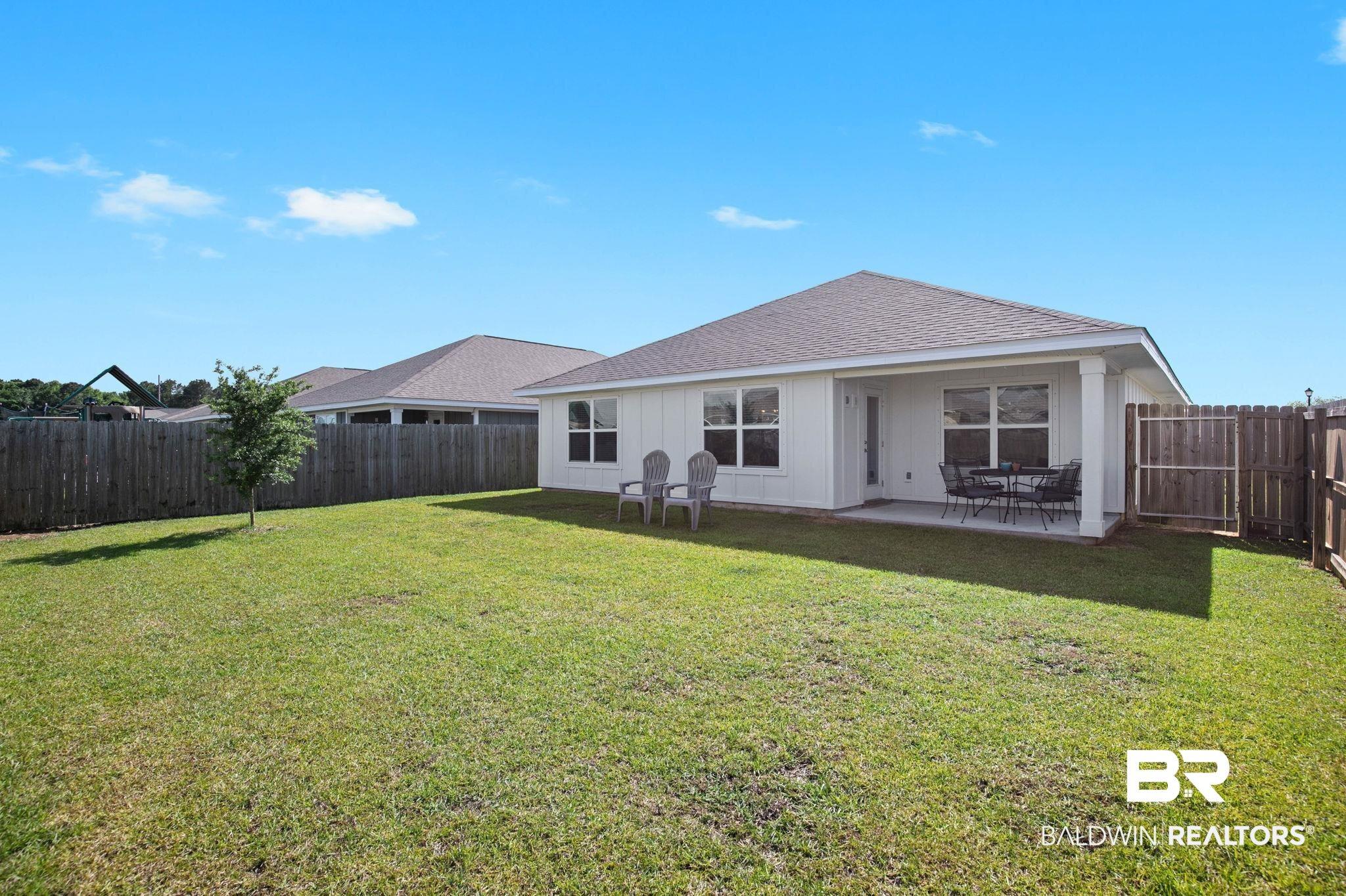 Image 2: Expansive green lawn with a privacy fence
