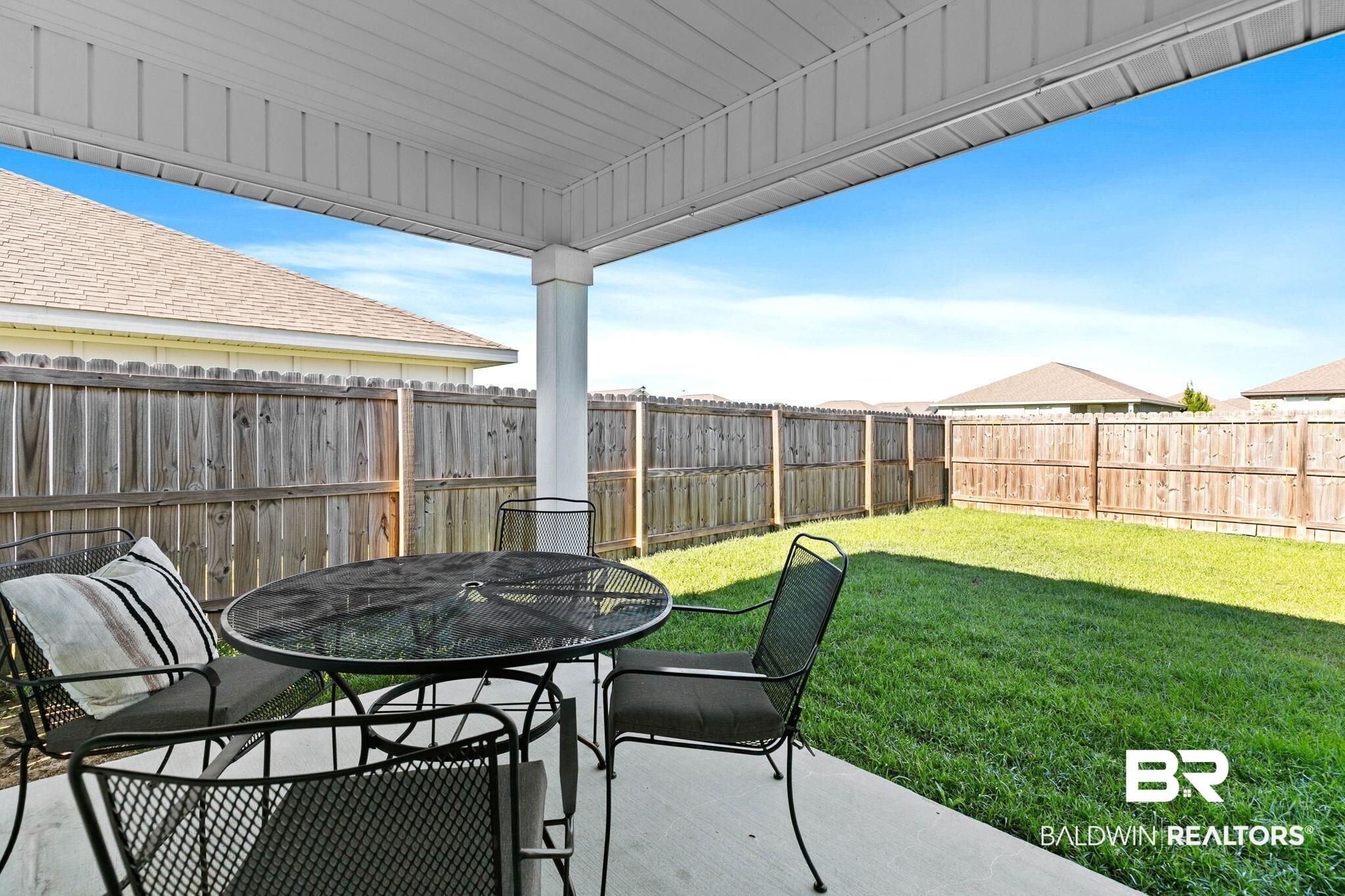 Image 3: Covered patio featuring a solid ceiling and a supporting column