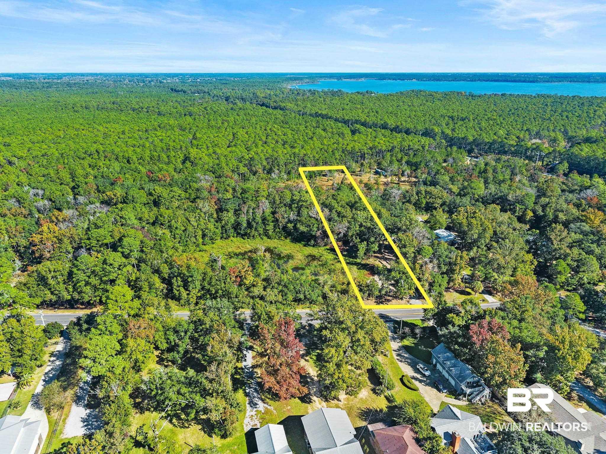 Image 4: Aerial view of property's location featuring property parcel outlined and a large body of water