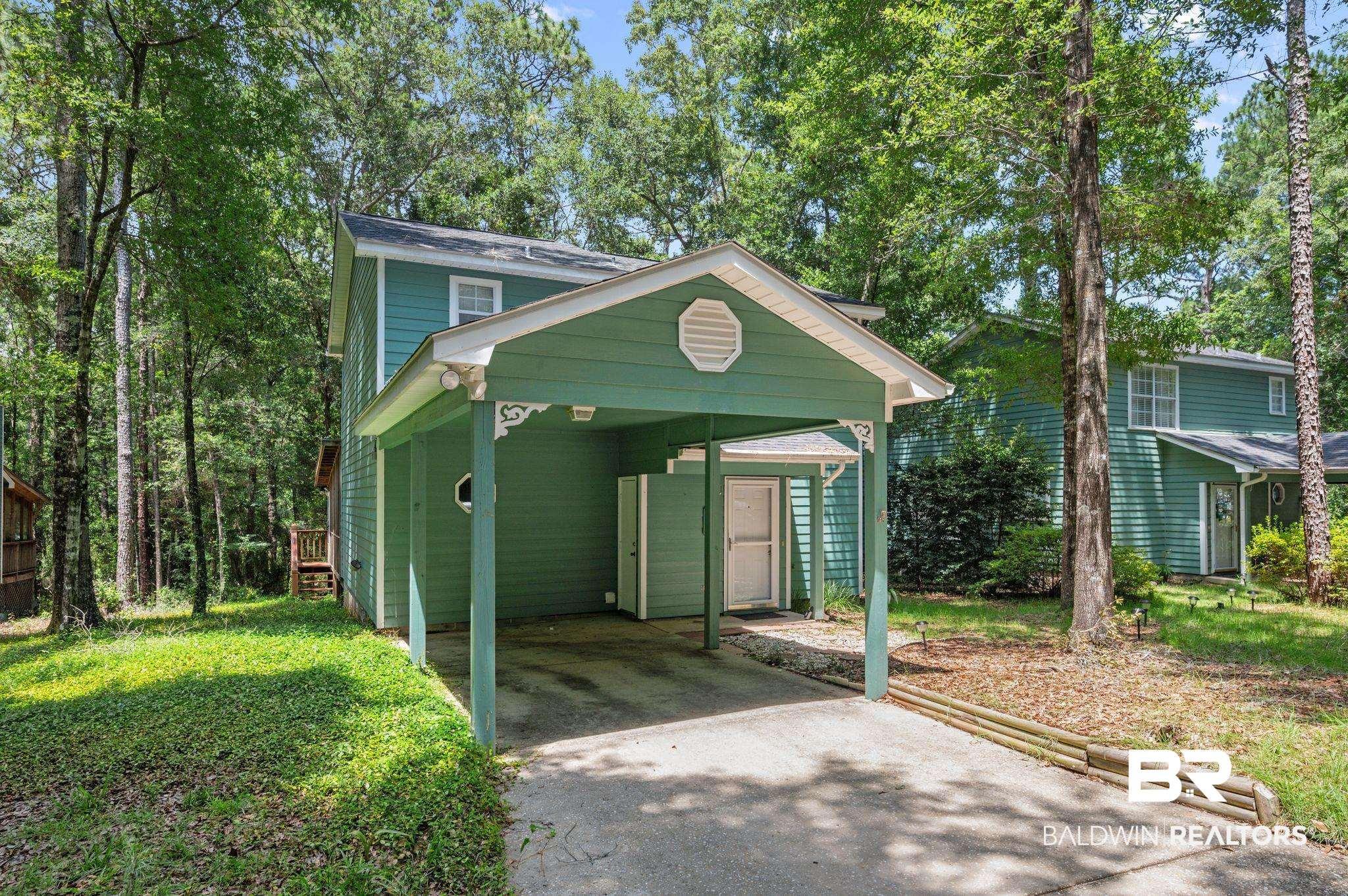 Image 2: Two-story home with a carport and dedicated storage area