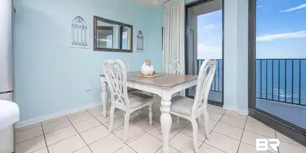 Image 3: Dining space with light tile patterned floors, a water view, and a ceiling fan