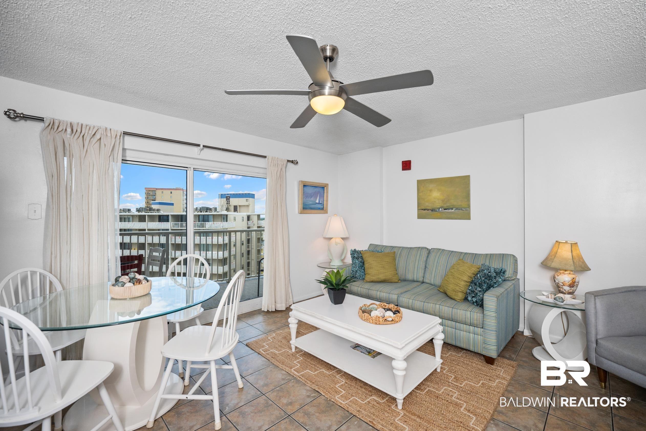 Image 4: Tiled living area featuring a textured ceiling and ceiling fan
