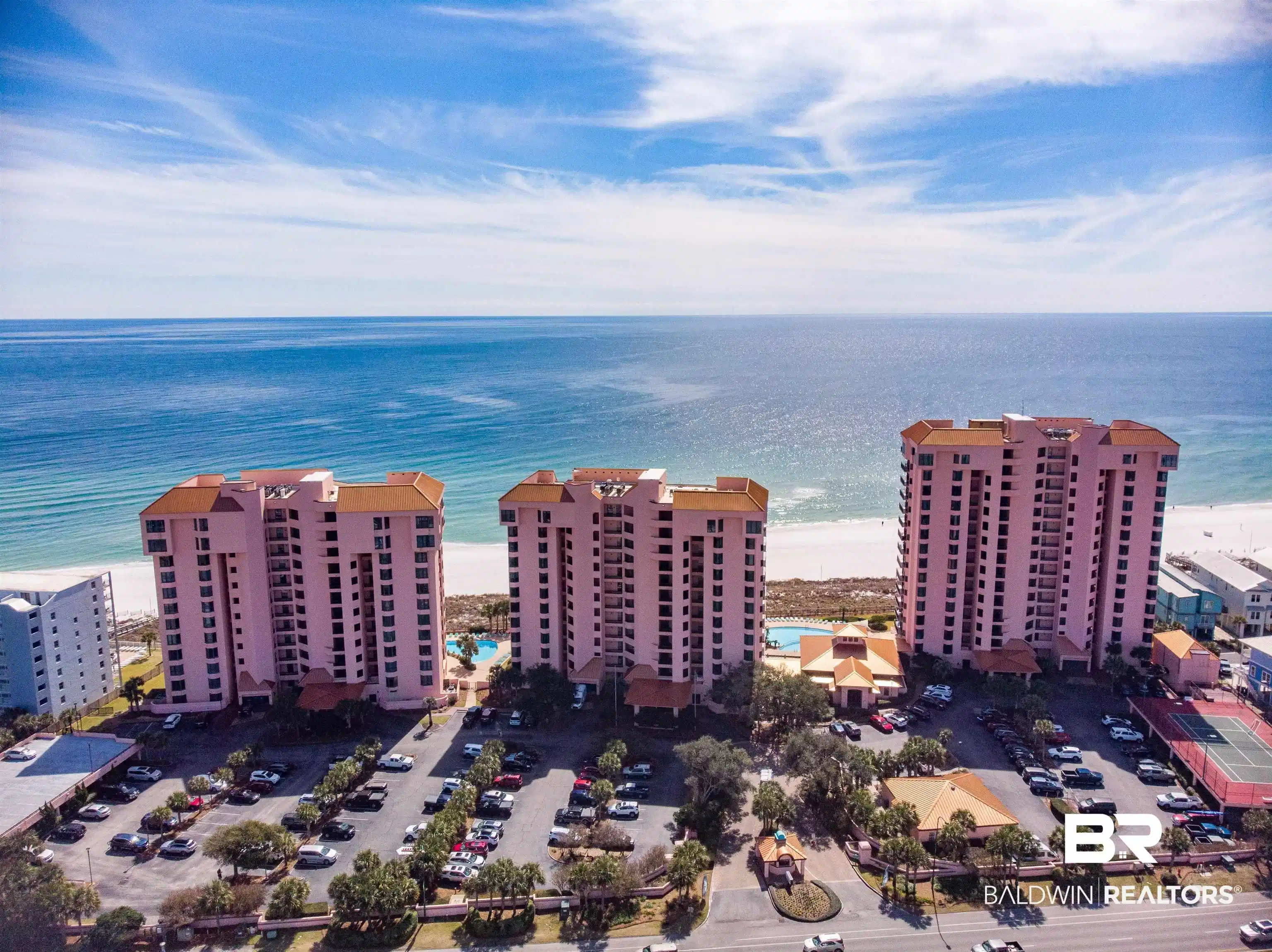 Image 1: Drone / aerial view of apartment complex and unending shoreline