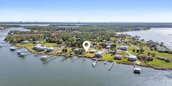 Image 4: Aerial perspective of suburban area featuring a nearby body of water