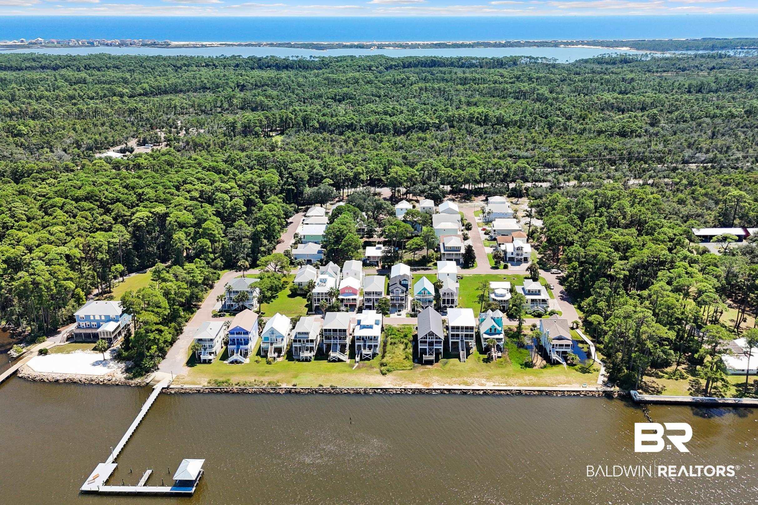 Image 4: Aerial perspective of suburban area with a nearby body of water