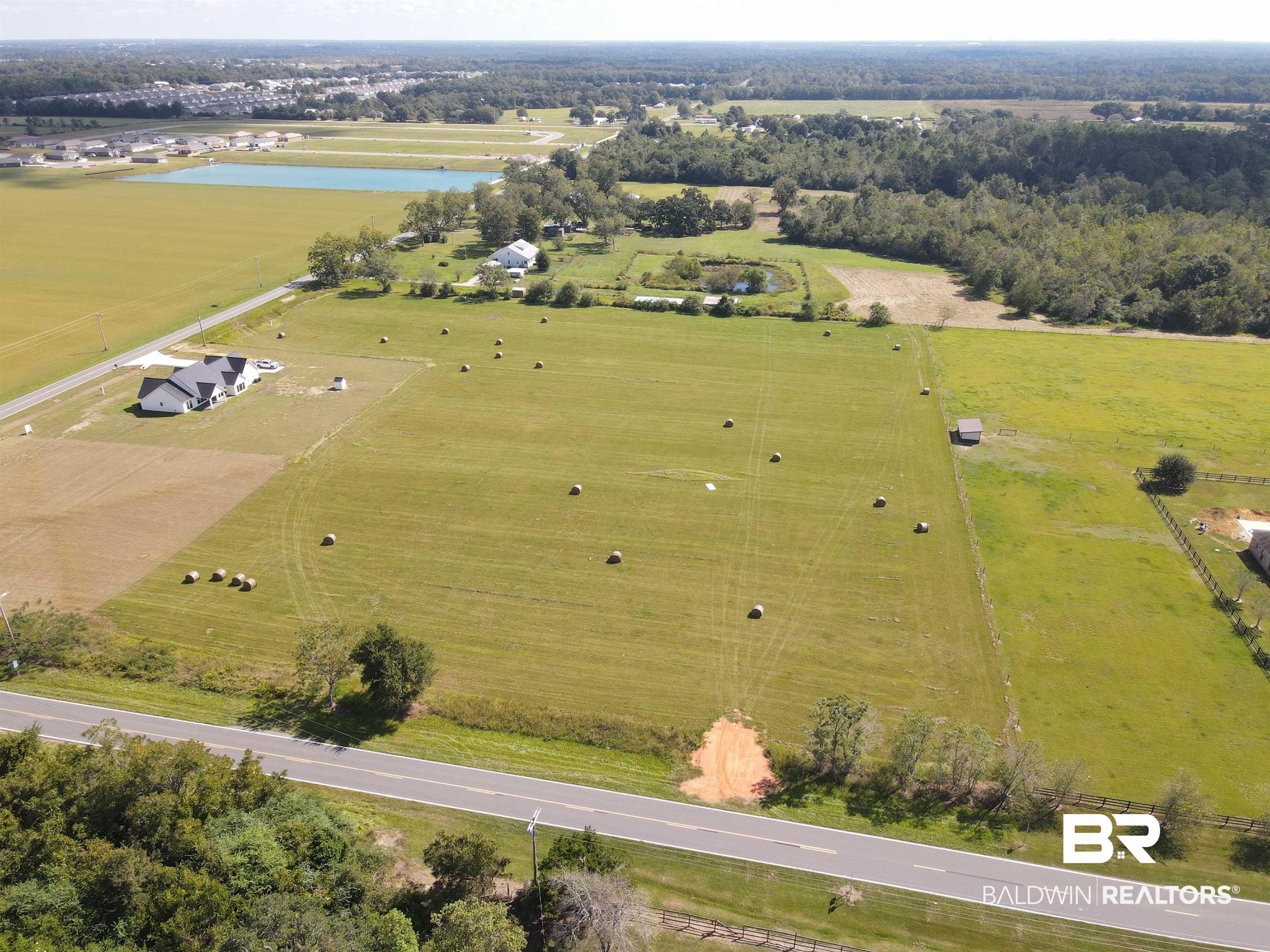 Image 4: Aerial overview of property's location featuring rural landscape and a nearby body of water