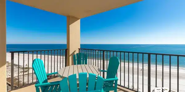 Image 4: Balcony featuring view of water and beach and outdoor dining space