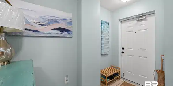 Image 4: Foyer entrance with a textured ceiling, tile patterned flooring, and baseboards