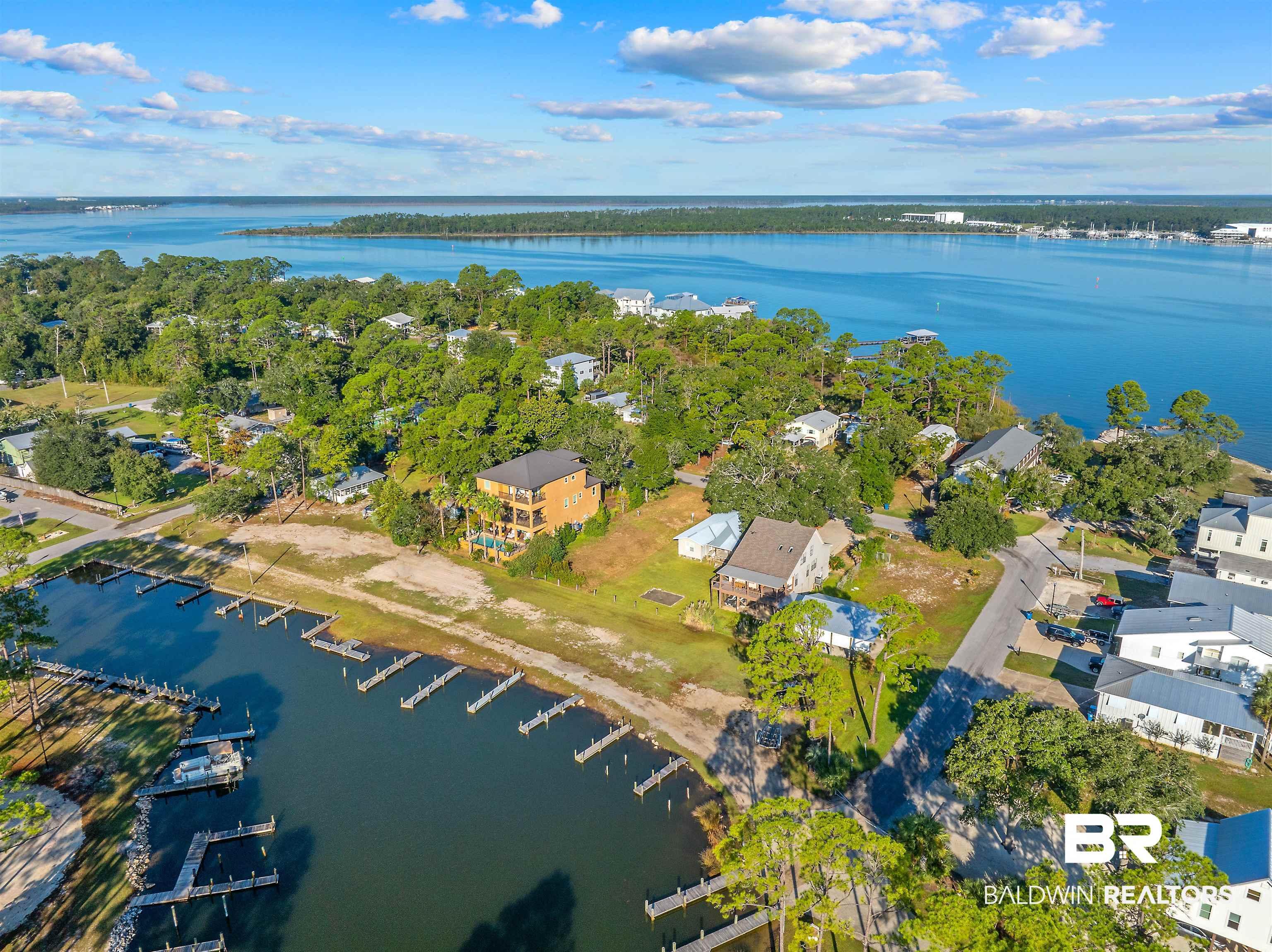Image 4: Aerial overview of property's location featuring a large body of water and nearby suburban area