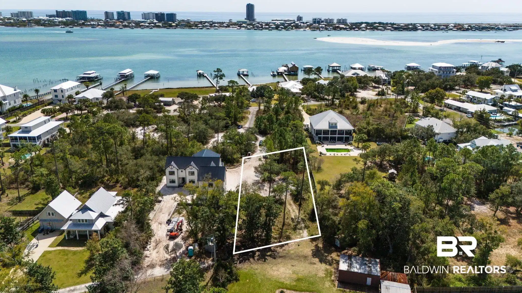 Image 1: View of urban area with property parcel outlined, a nearby body of water, and nearby suburban area