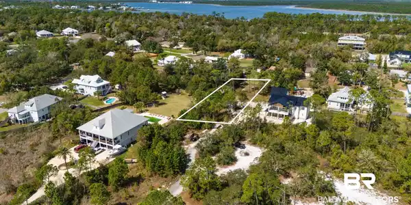 Image 3: Aerial perspective of suburban area with a nearby body of water and property boundaries highlighted