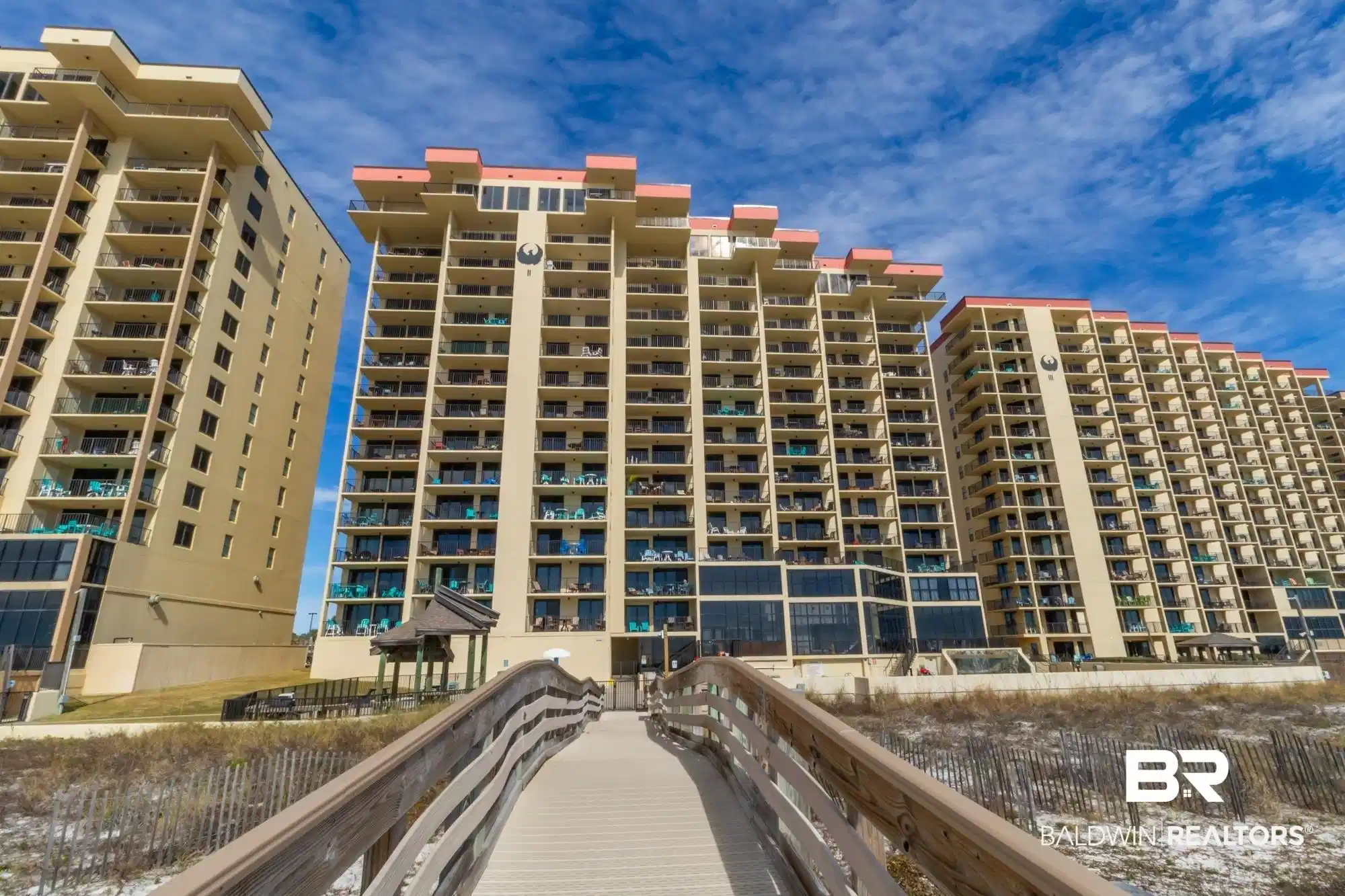 Image 1: Expansive multi-story building featuring numerous private balconies and a tiered architectural design