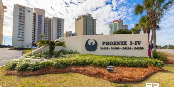 Image 2: Phoenix I-IV property entrance sign featuring a prominent emblem and building addresses