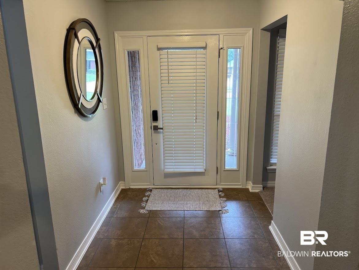 Image 3: Entryway featuring a white paneled door with glass inserts and side lites, complemented by privacy blinds