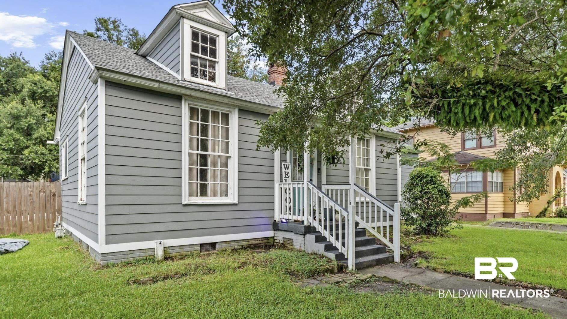 Image 3: View of front of house with roof with shingles, a chimney, and crawl space