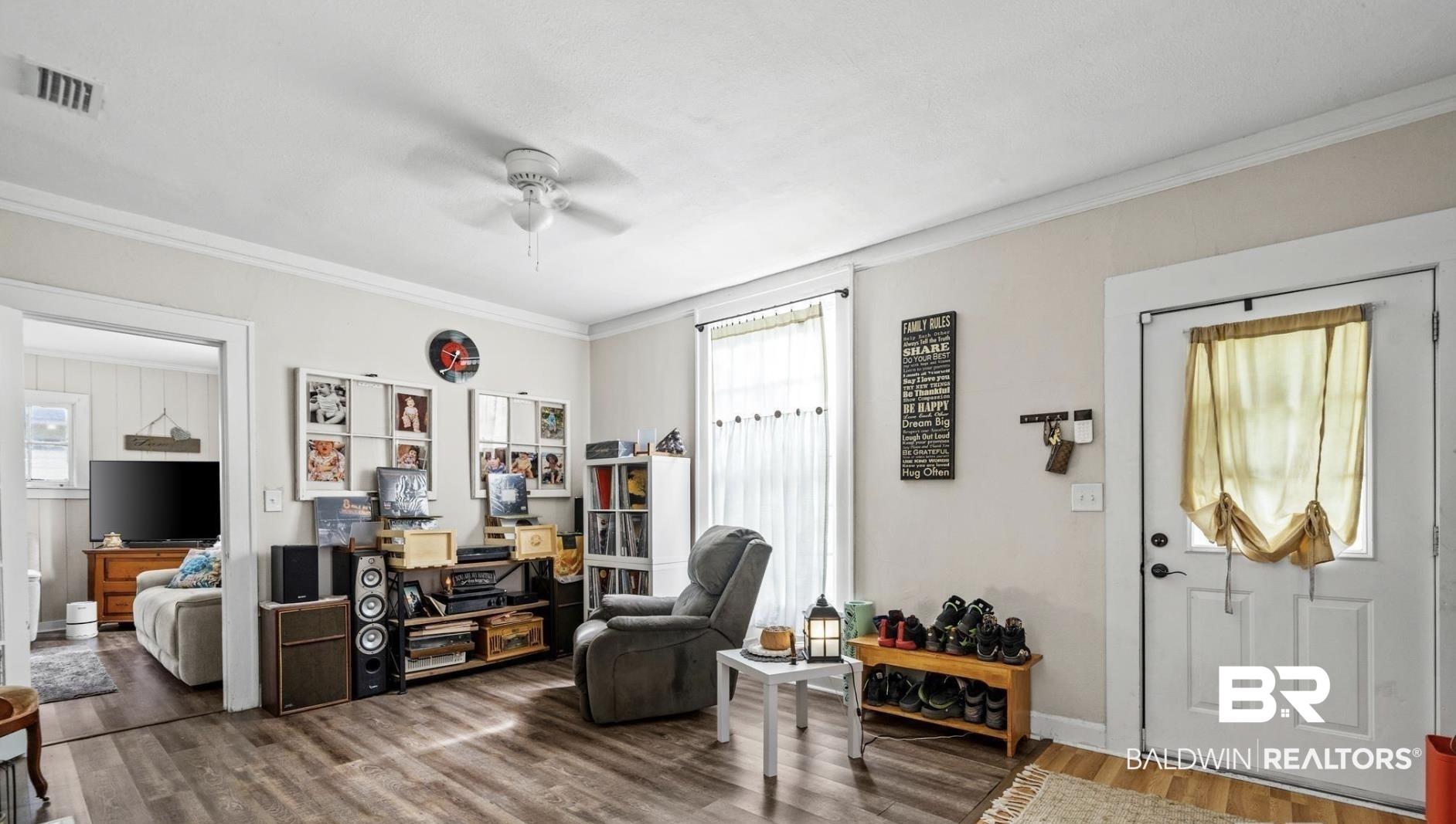 Image 4: Entryway featuring crown molding, wood finished floors, and ceiling fan