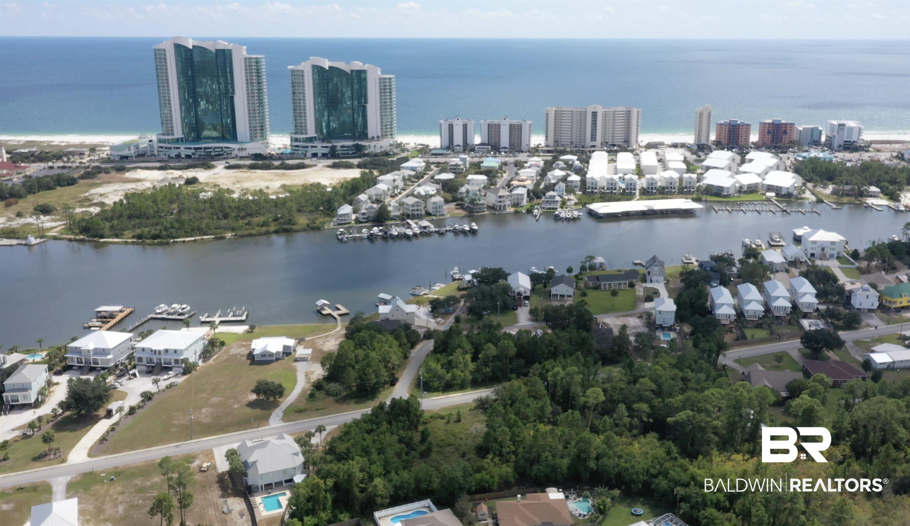 Image 3: Aerial overview of property's location featuring a nearby body of water and nearby suburban area