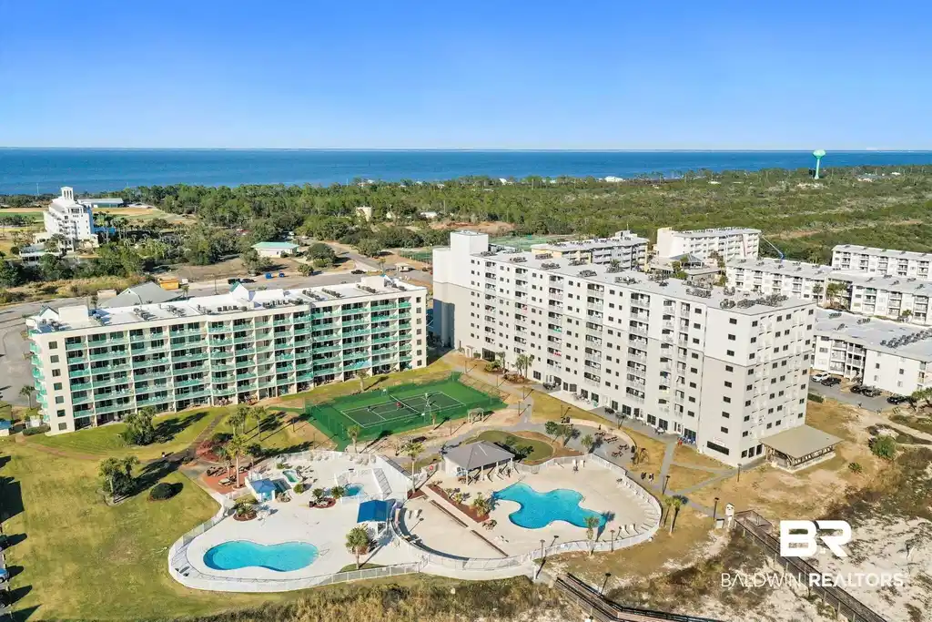 Image 1: Aerial view of a pool and apartment complex
