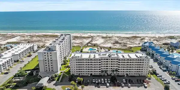 Image 3: Drone / aerial view of extended coastline and apartment complex / building