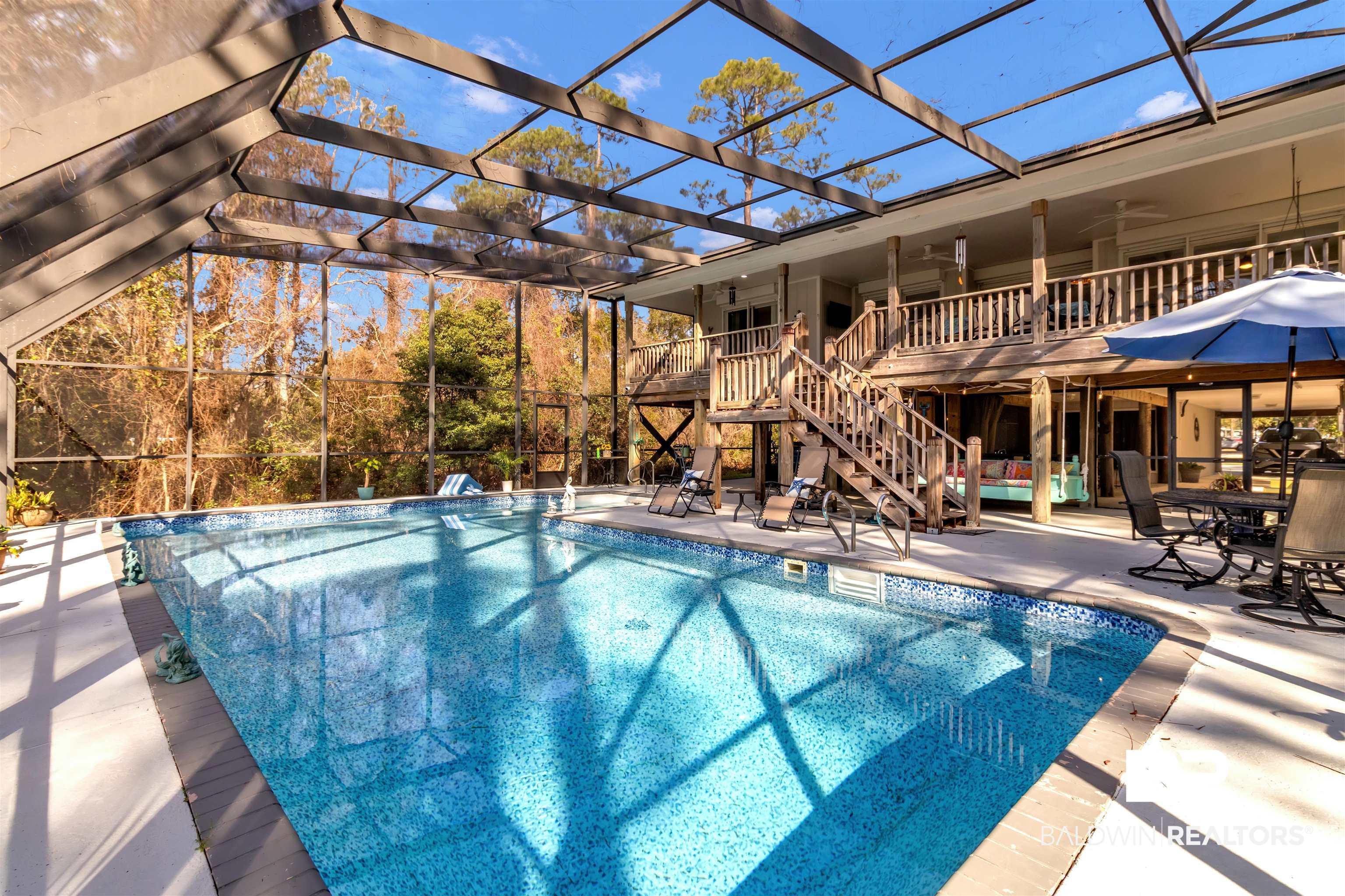 Image 2: Swimming pool with a patio area, a lanai, and outdoor dining space