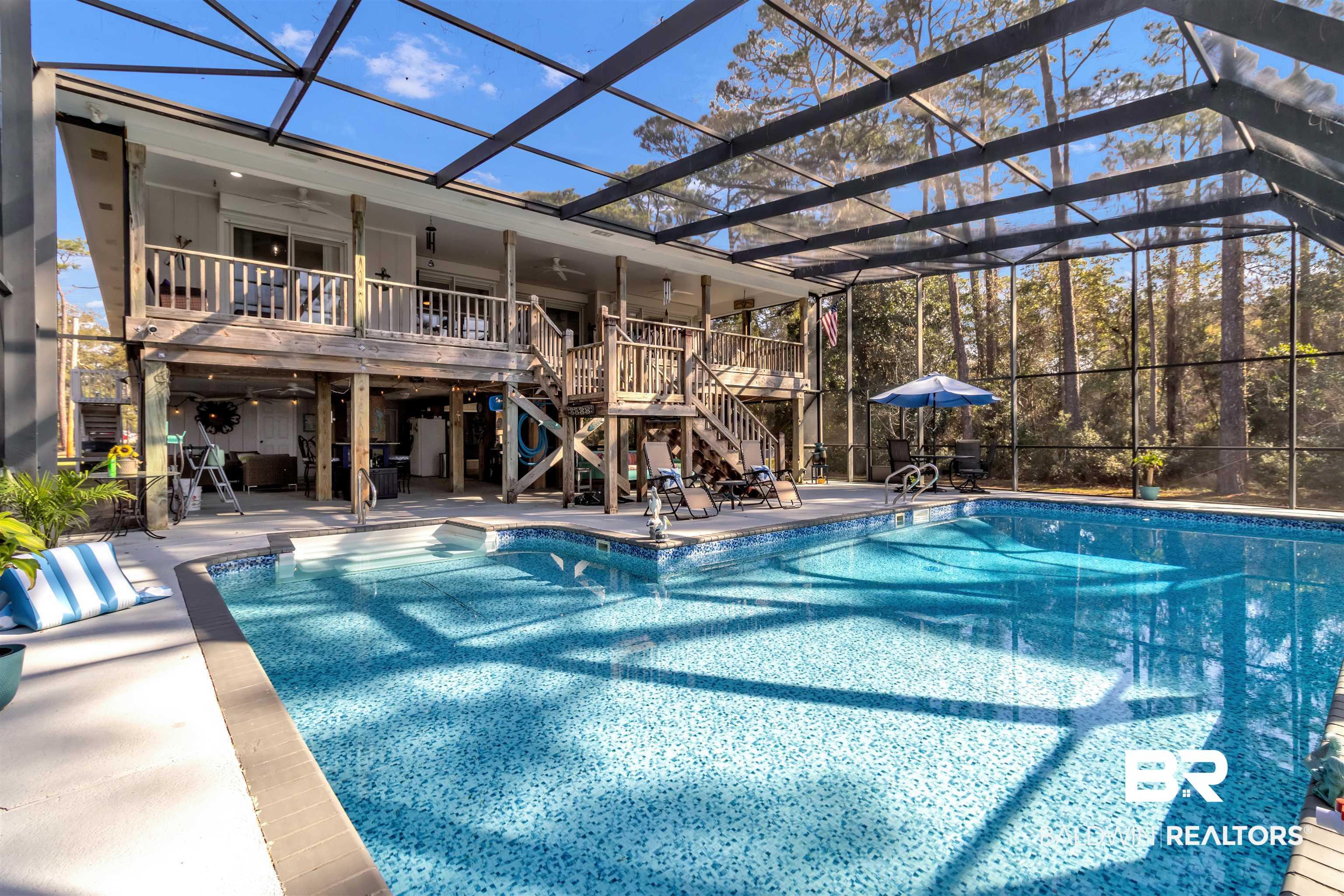 Image 3: Swimming pool with a patio, glass enclosure, and a deck