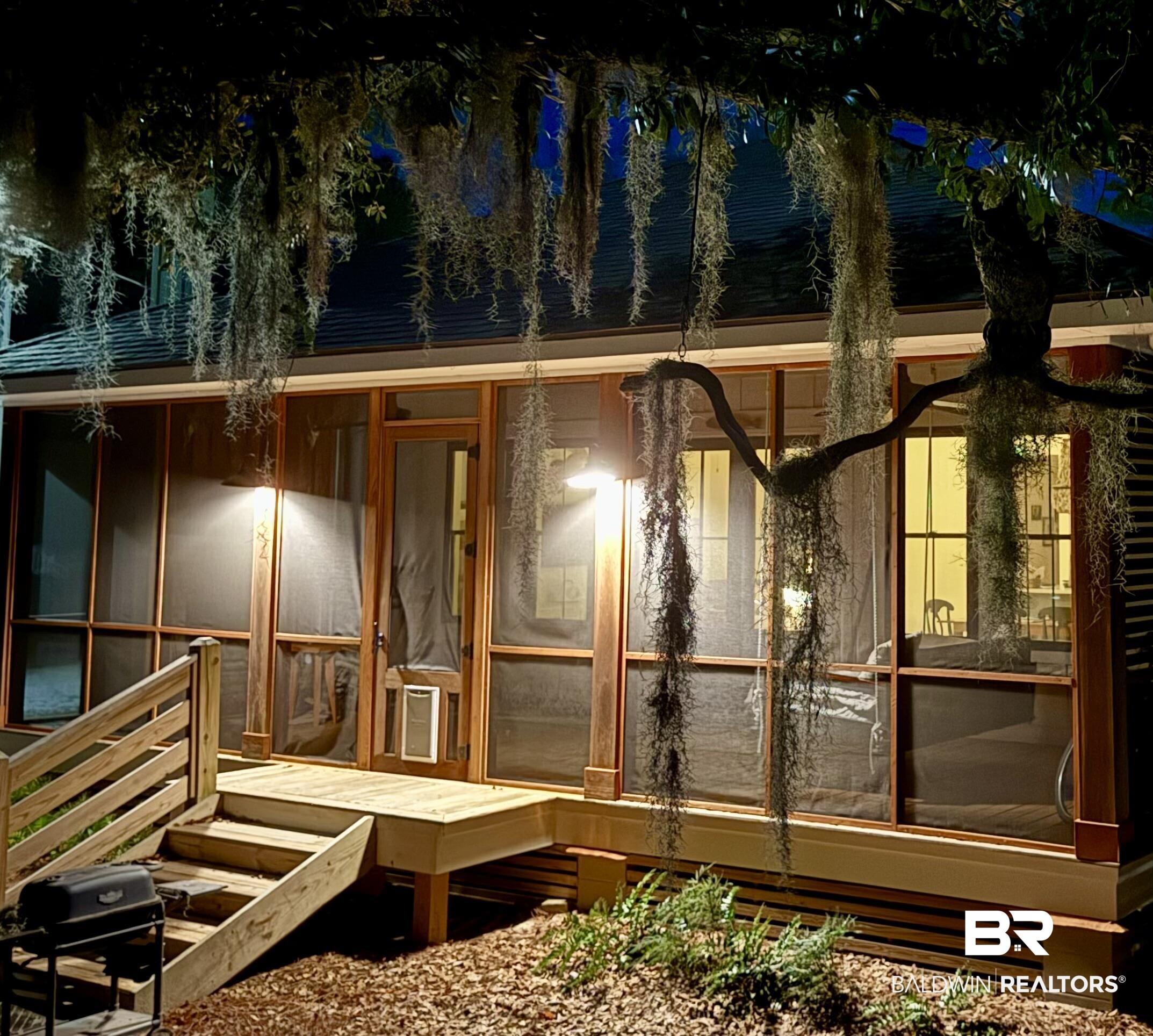 Image 3: Screened-in porch featuring wood-frame construction and integrated lighting