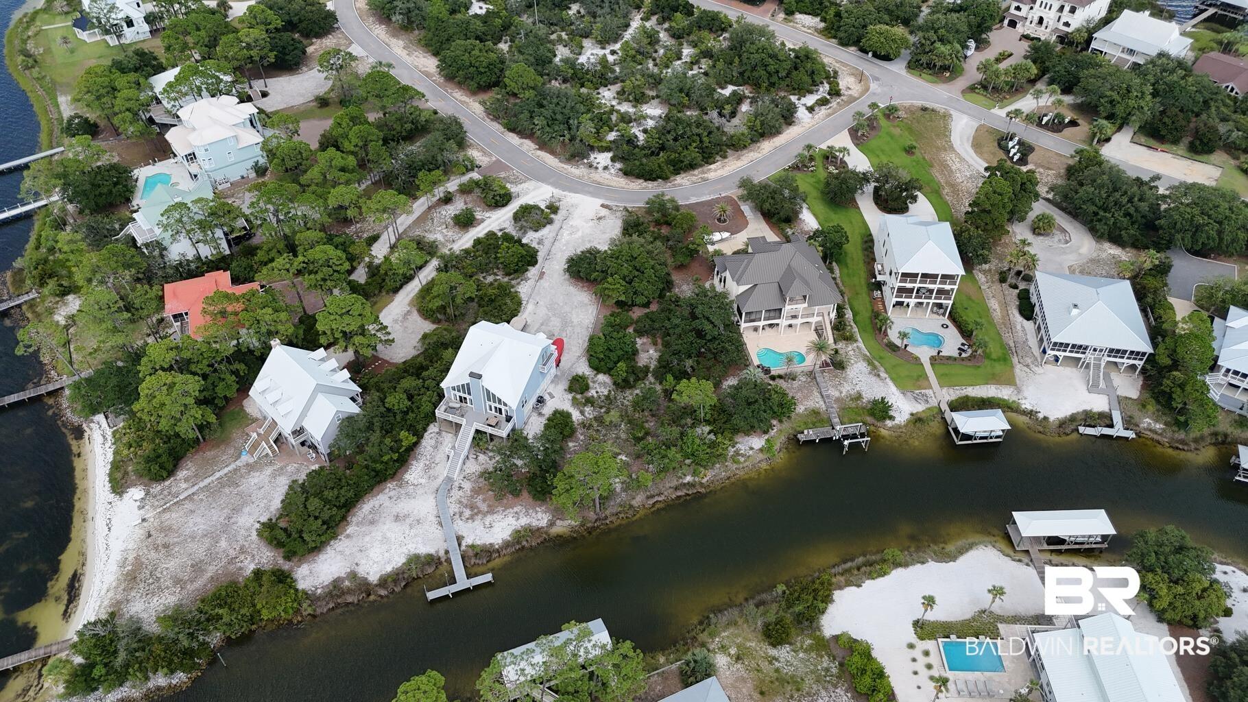 Image 2: View of property location featuring a large body of water and nearby suburban area
