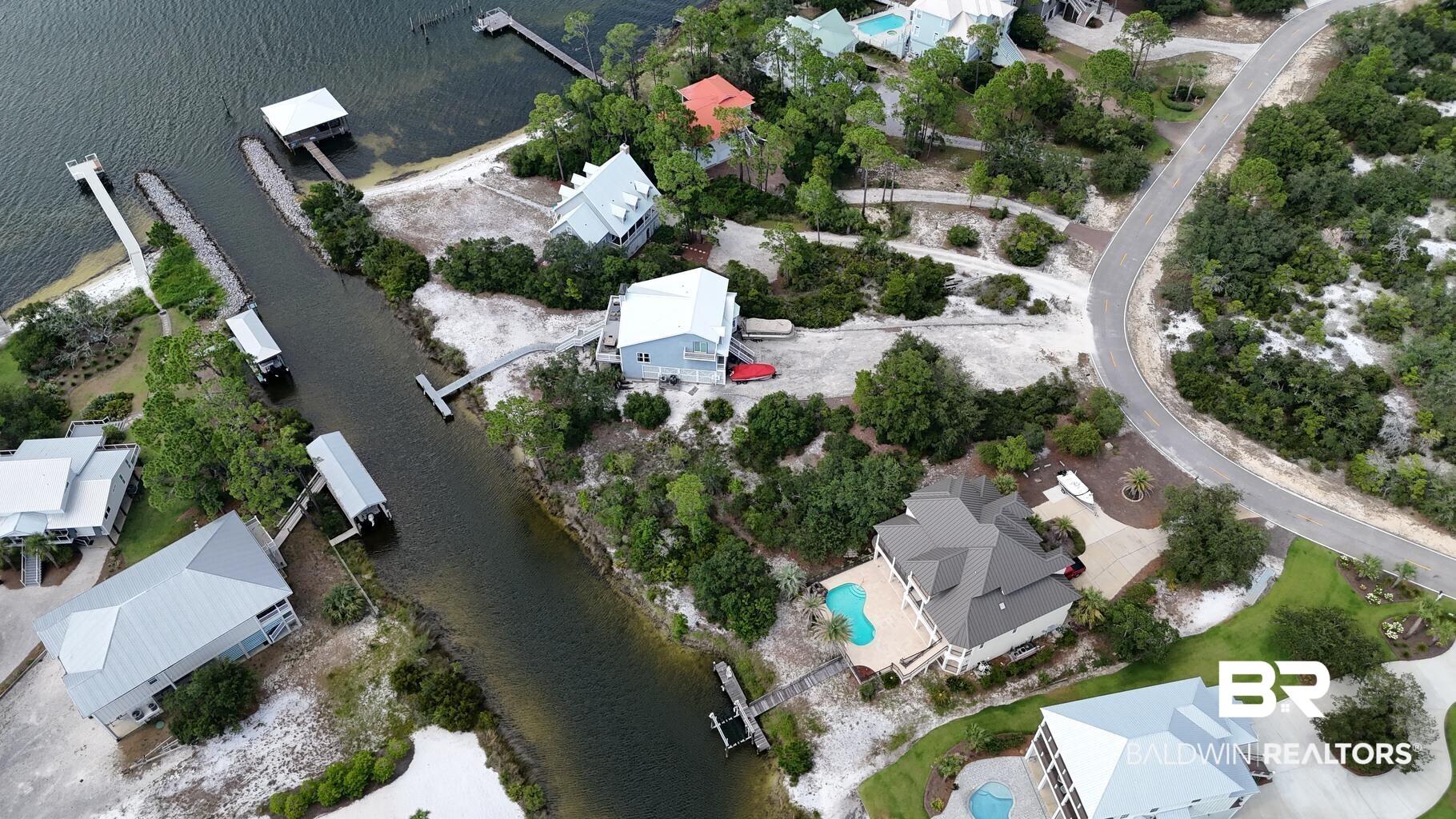 Image 3: View of property location featuring a nearby body of water and nearby suburban area