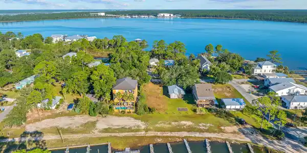 Image 2: Aerial view of residential area with a nearby body of water