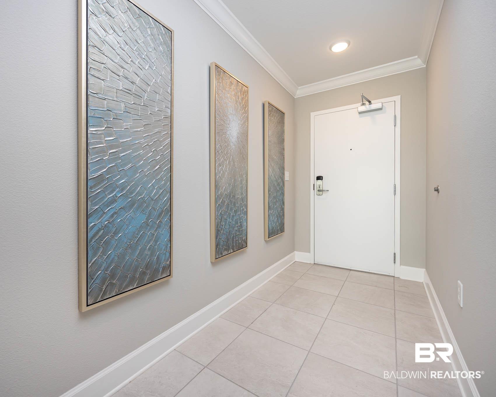 Image 3: Doorway with tile patterned floors and ornamental molding