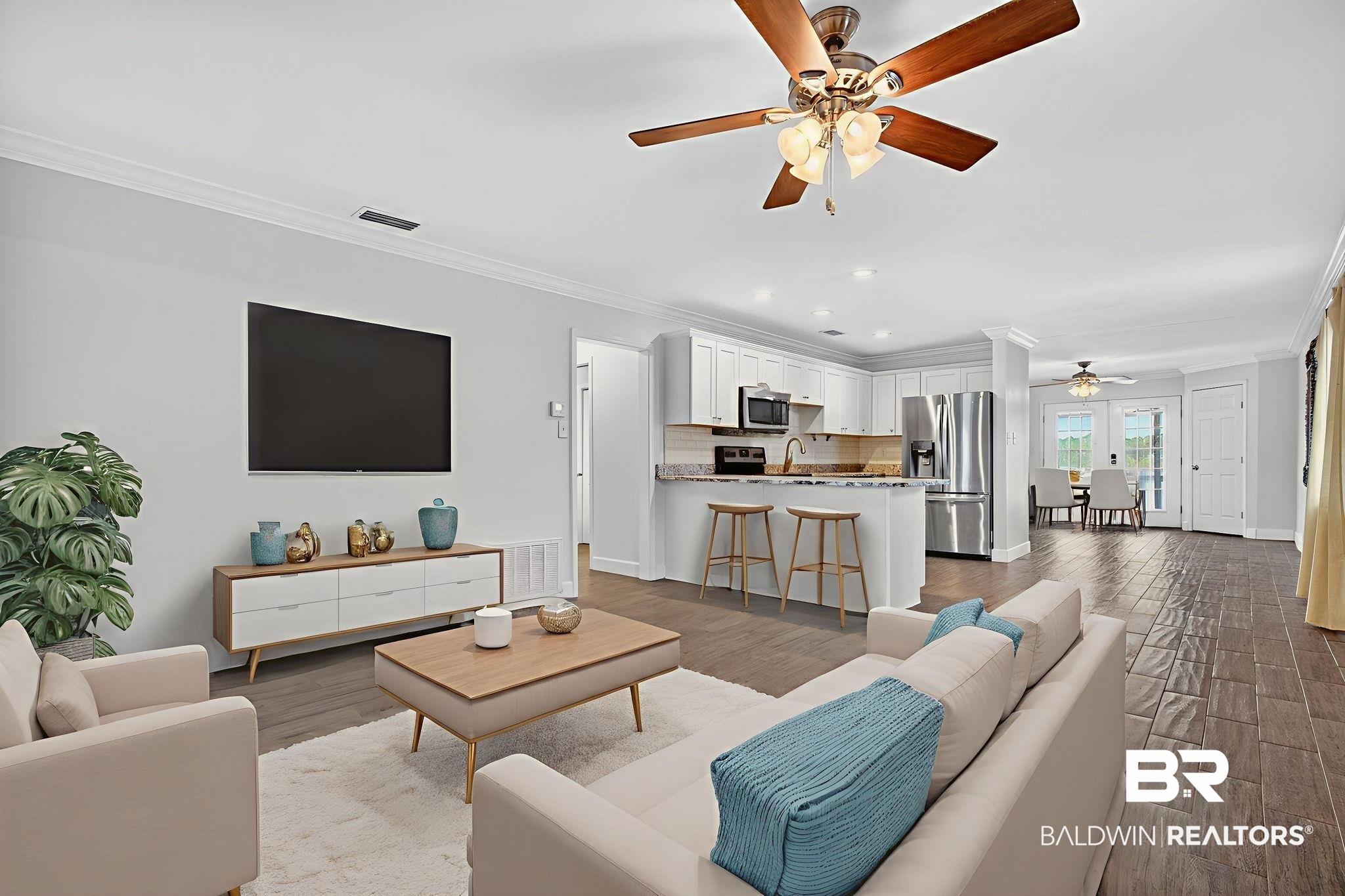 Image 3: Living room with ornamental molding, ceiling fan, wood finished floors, and recessed lighting