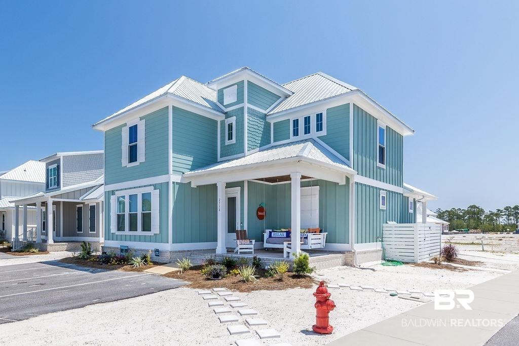 Image 1: View of front of house with a porch and board and batten siding