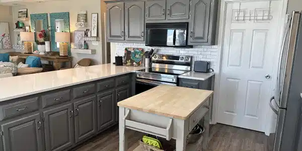 Image 4: Kitchen featuring grey cabinetry, white subway tile backsplash, and wood-finish flooring