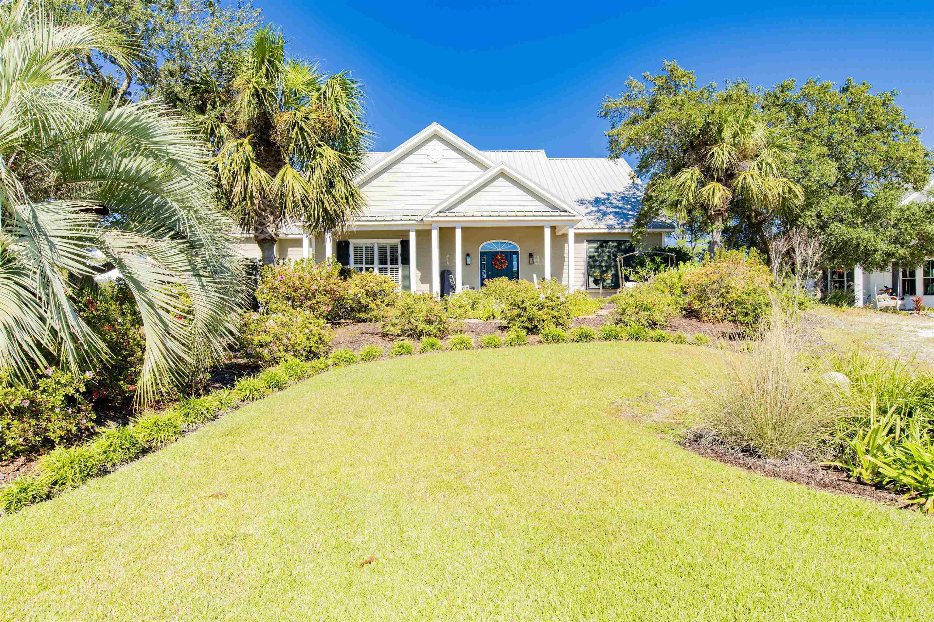 Image 2: View of front of home with a front lawn and a porch
