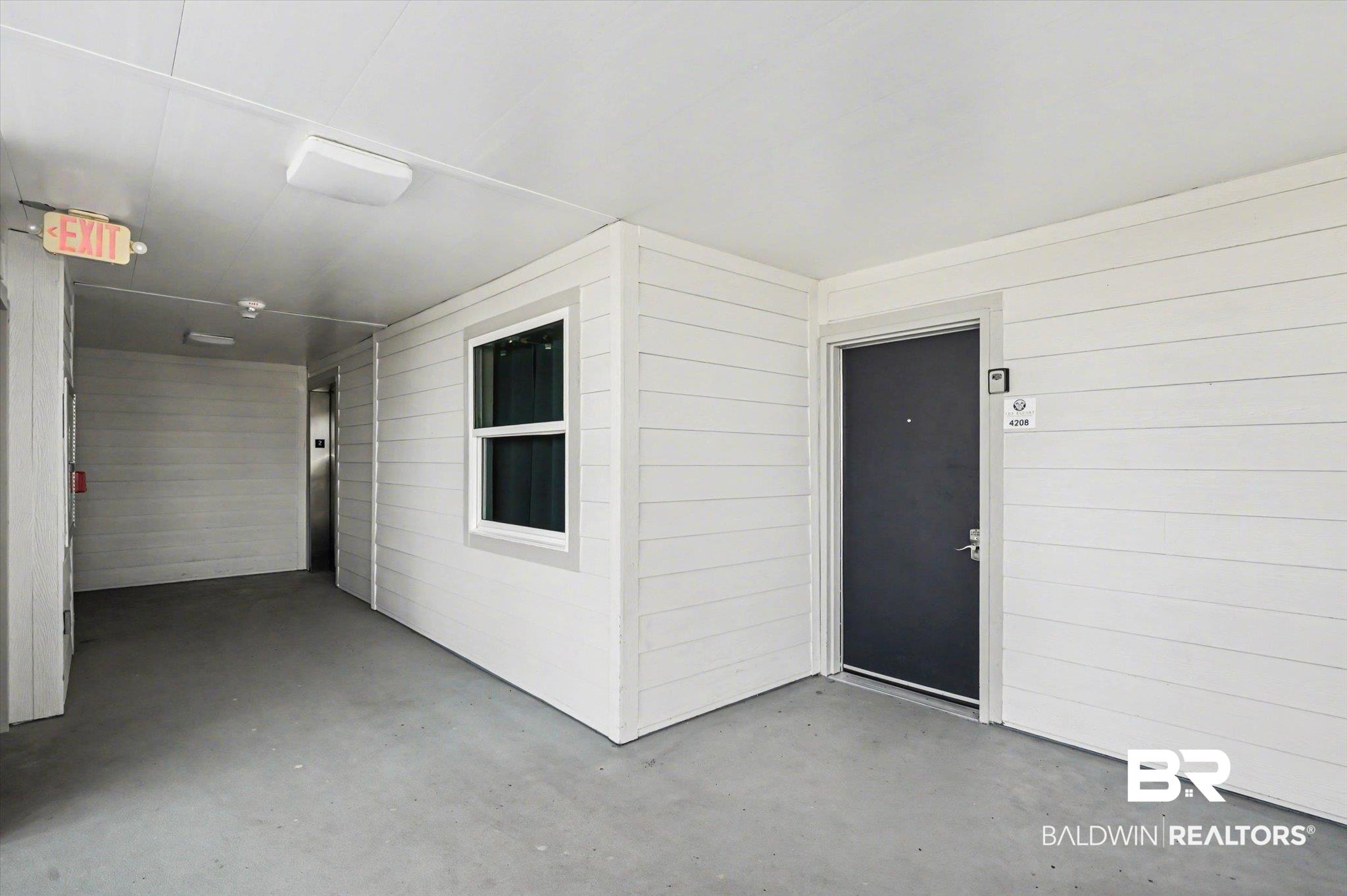 Image 3: View of exterior entry with a patio