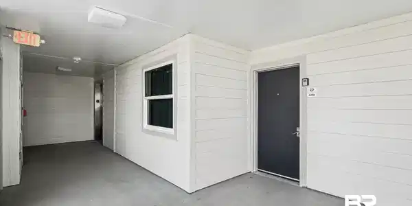 Image 3: View of exterior entry with a patio