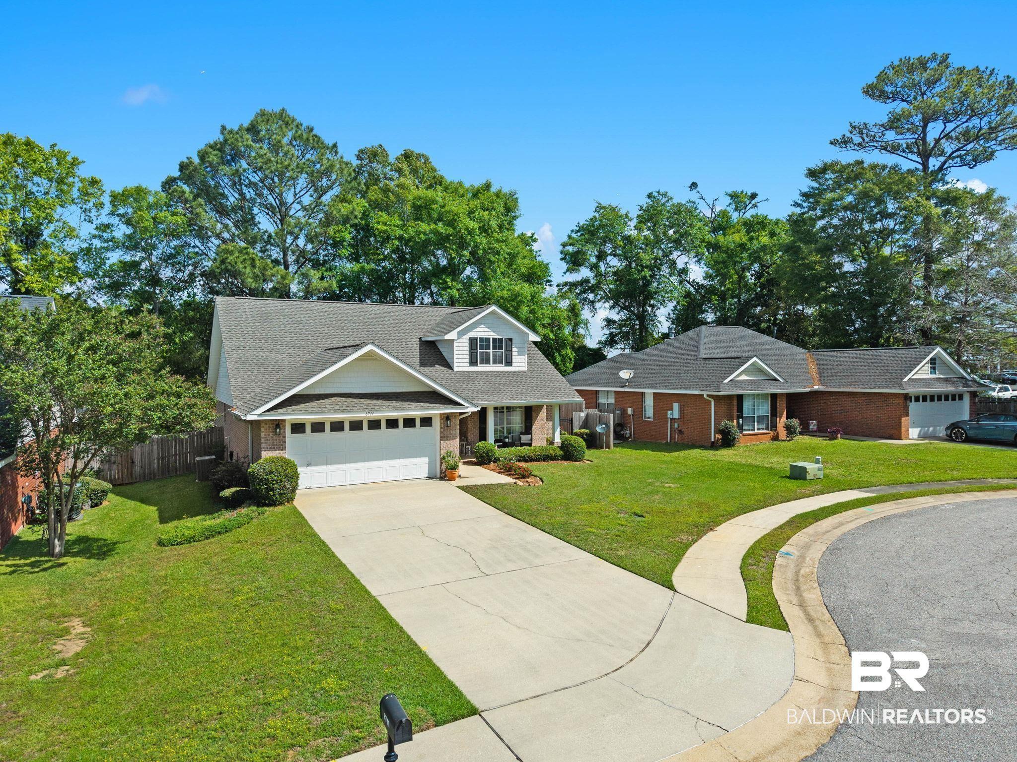 Image 4: View of front of property with brick siding, driveway, roof with shingles, and an attached garage