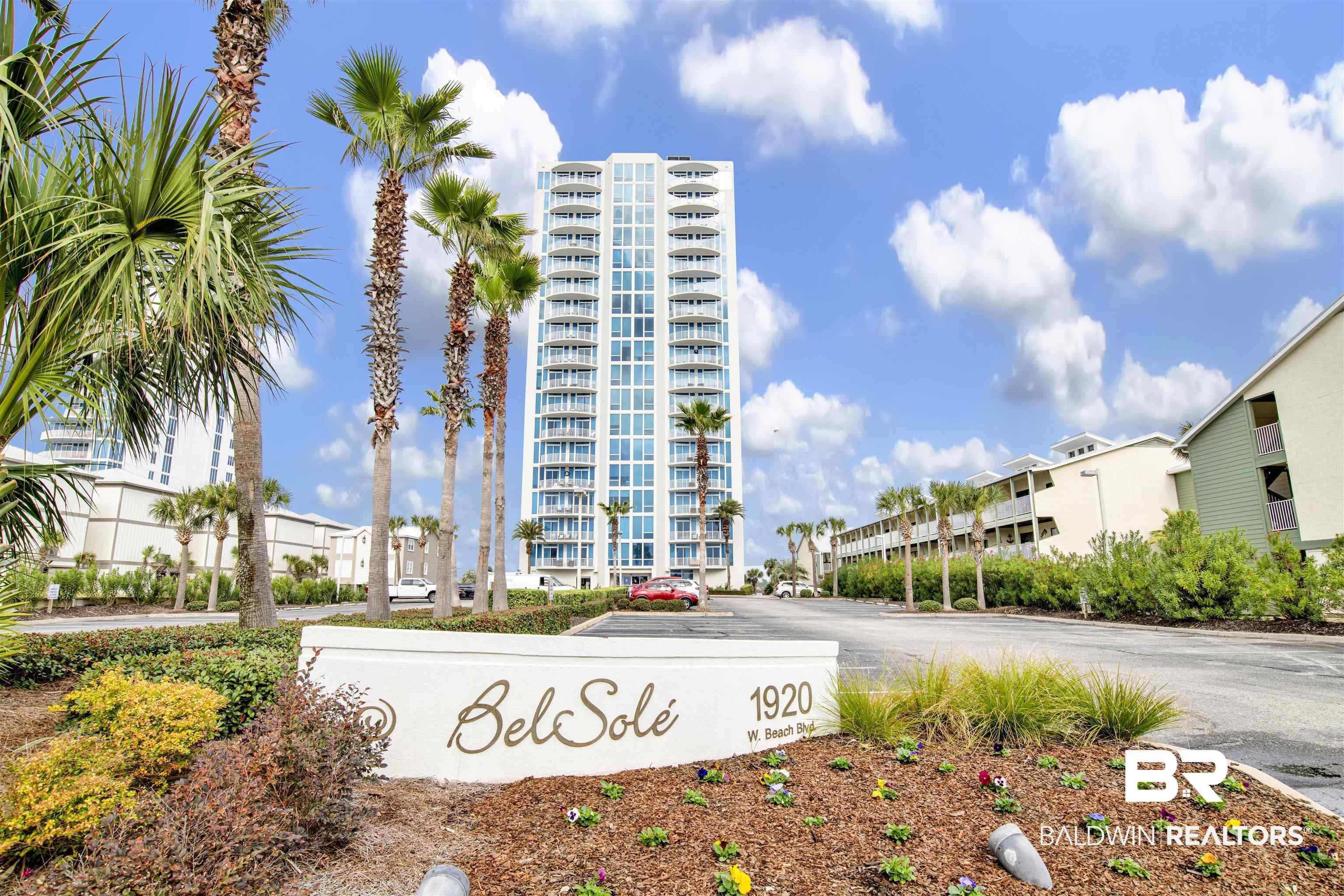 Image 2: High-rise residential building featuring multiple balconies and a white exterior