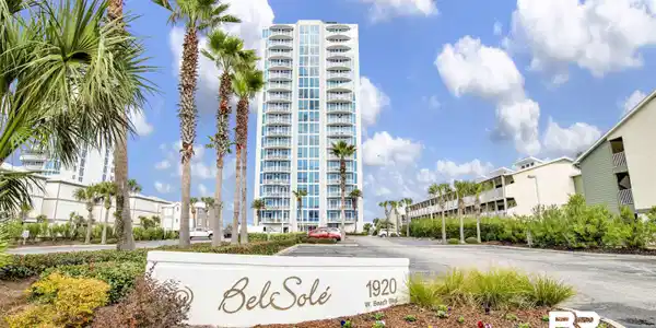 Image 2: High-rise residential building featuring multiple balconies and a white exterior