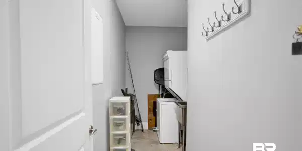 Image 3: Utility area featuring a built-in stainless steel sink, tiled flooring, and a wall-mounted coat rack