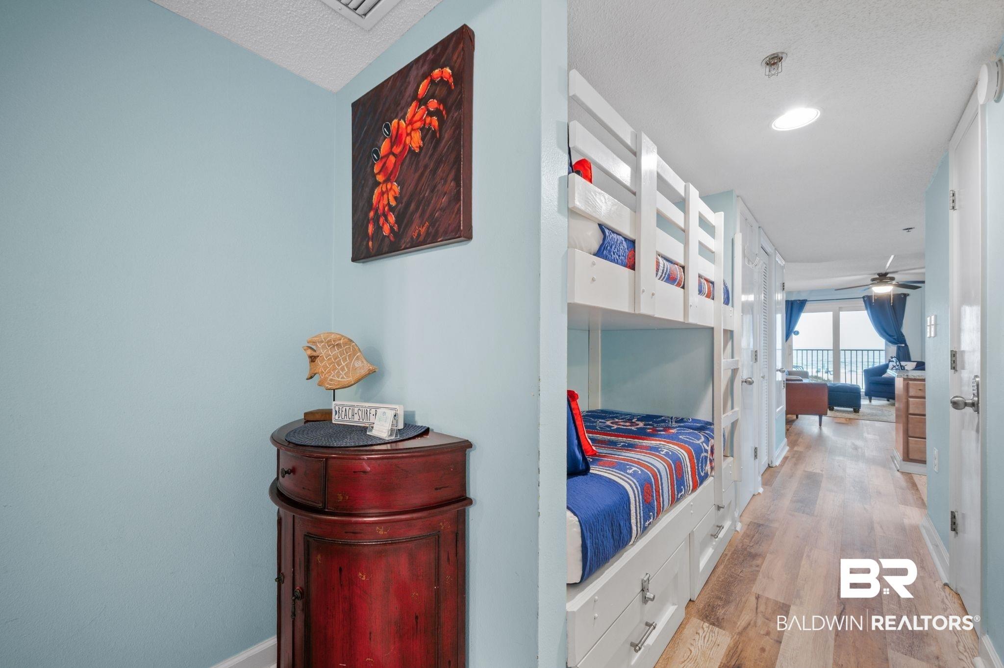 Image 2: Corridor with light wood-style flooring, french doors, a textured ceiling, and baseboards