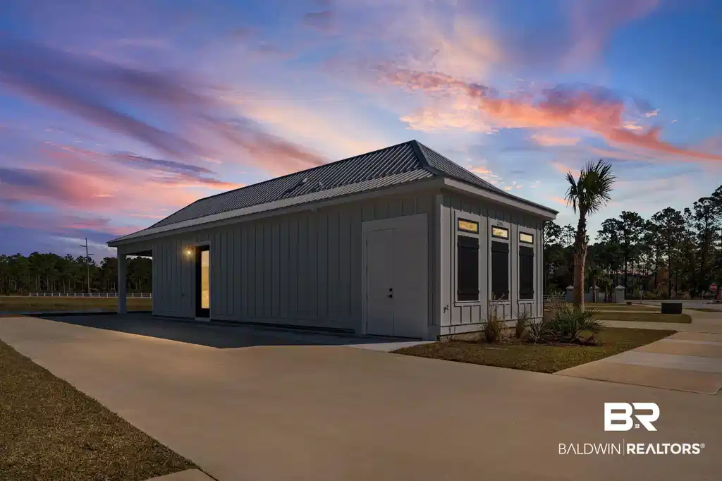 Image 1: View of side of home with board and batten siding and a metal roof