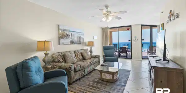 Image 3: Living area featuring ceramic tile flooring, a ceiling fan with integrated lighting, and direct access to an exterior balcony through sliding glass doors